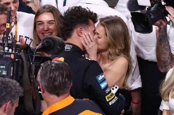 McLaren's Lando Norris celebrates with his girlfriend Magui Corceiro after becoming the 2025 Formula One World Champion after a third-place finish at the  Abu Dhabi F1 Grand Prix at the Yas Marina Circuit, Abu Dhabi, United Arab Emirates, on Sunday 