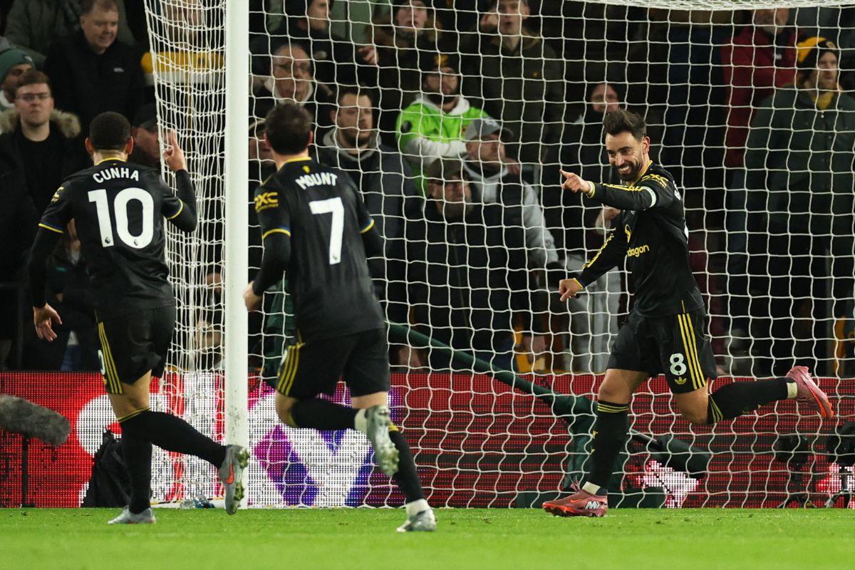 Manchester United's Bruno Fernandes celebrates with Matheus Cunha on scoring their first goal against Wolverhampton Wanderers at Molineux Stadium, Wolverhampton, Britain on Monday