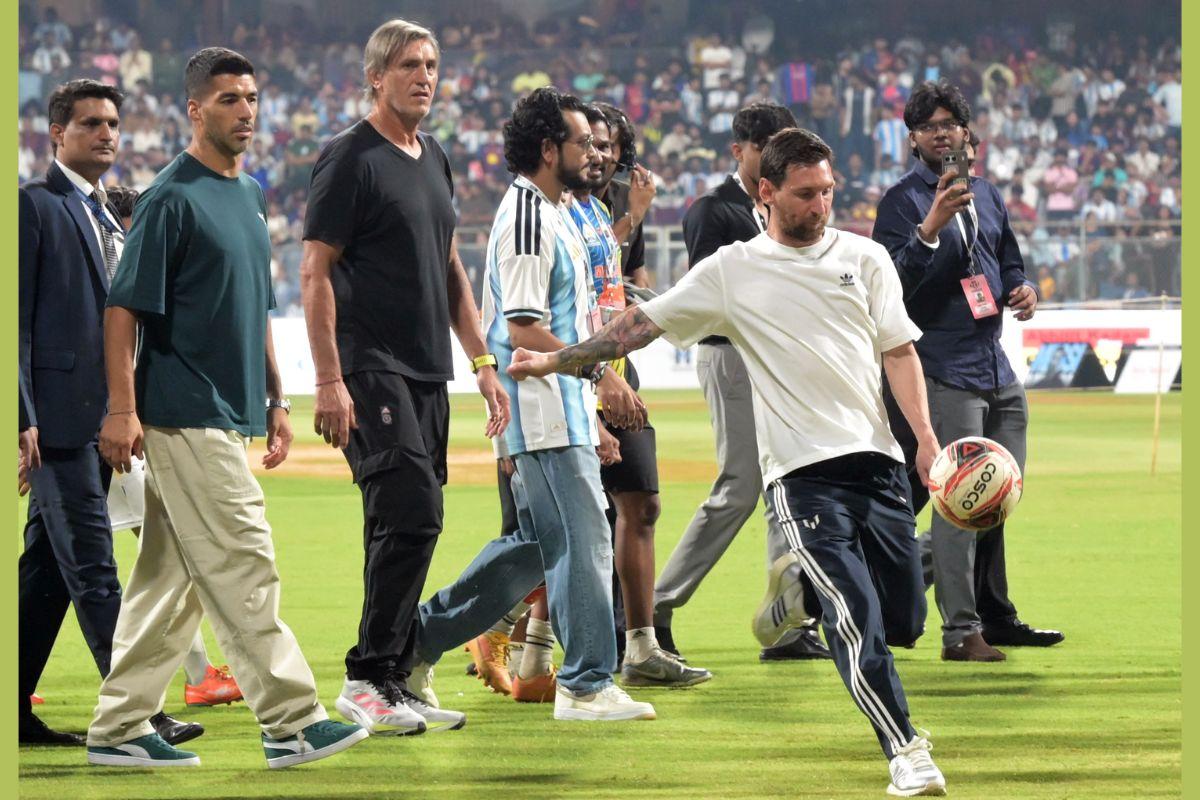 Lionel Messi kicks the ball into the stands as he takes a lap of honour at the Wankhede Stadium on Sunday