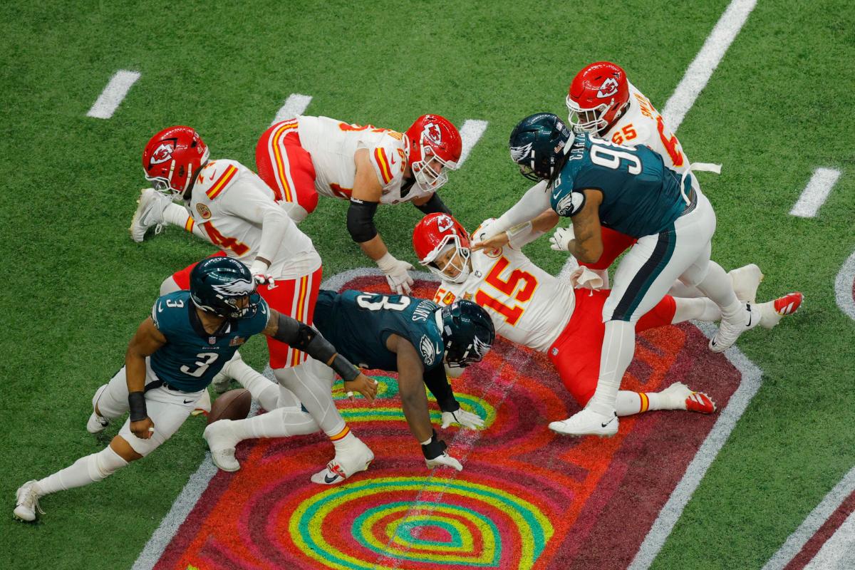 Kansas City Chiefs' Patrick Mahomes is hit in the face by Philadelphia Eagles' Jalen Carter as the ball is loose