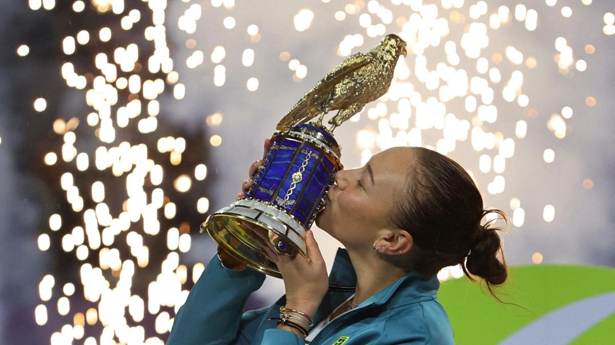 Amanda Anisimova of the United States kisses the trophy as she celebrates beating Latvia's Jelena Ostapenko in the final of the Doha Open at Khalifa International Tennis and Squash Complex, Doha, Qatar, on Saturday.