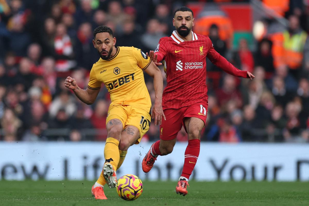 Wolverhampton Wanderers' Matheus Cunha in action beats Liverpool's Mohamed Salah to the ball during their Premier League match at Anfield, Liverpool