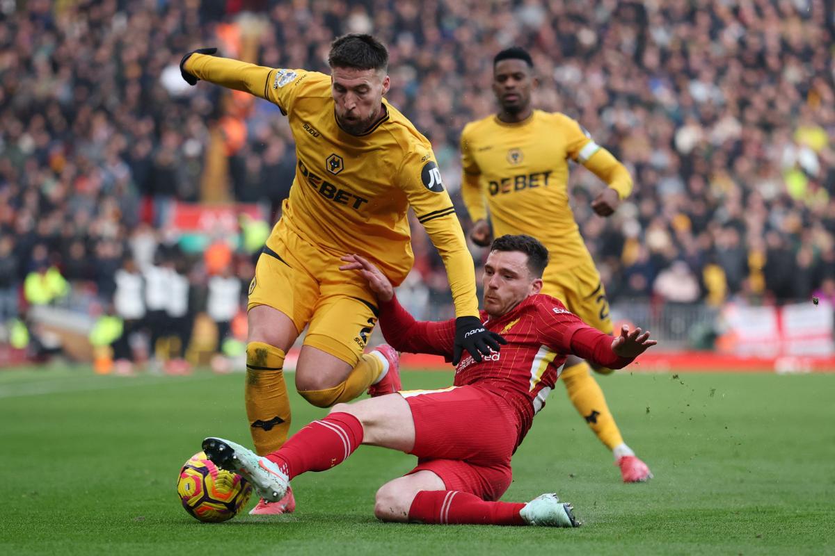 Wolverhampton Wanderers' Matt Doherty is challenged by Liverpool's Andrew Robertson