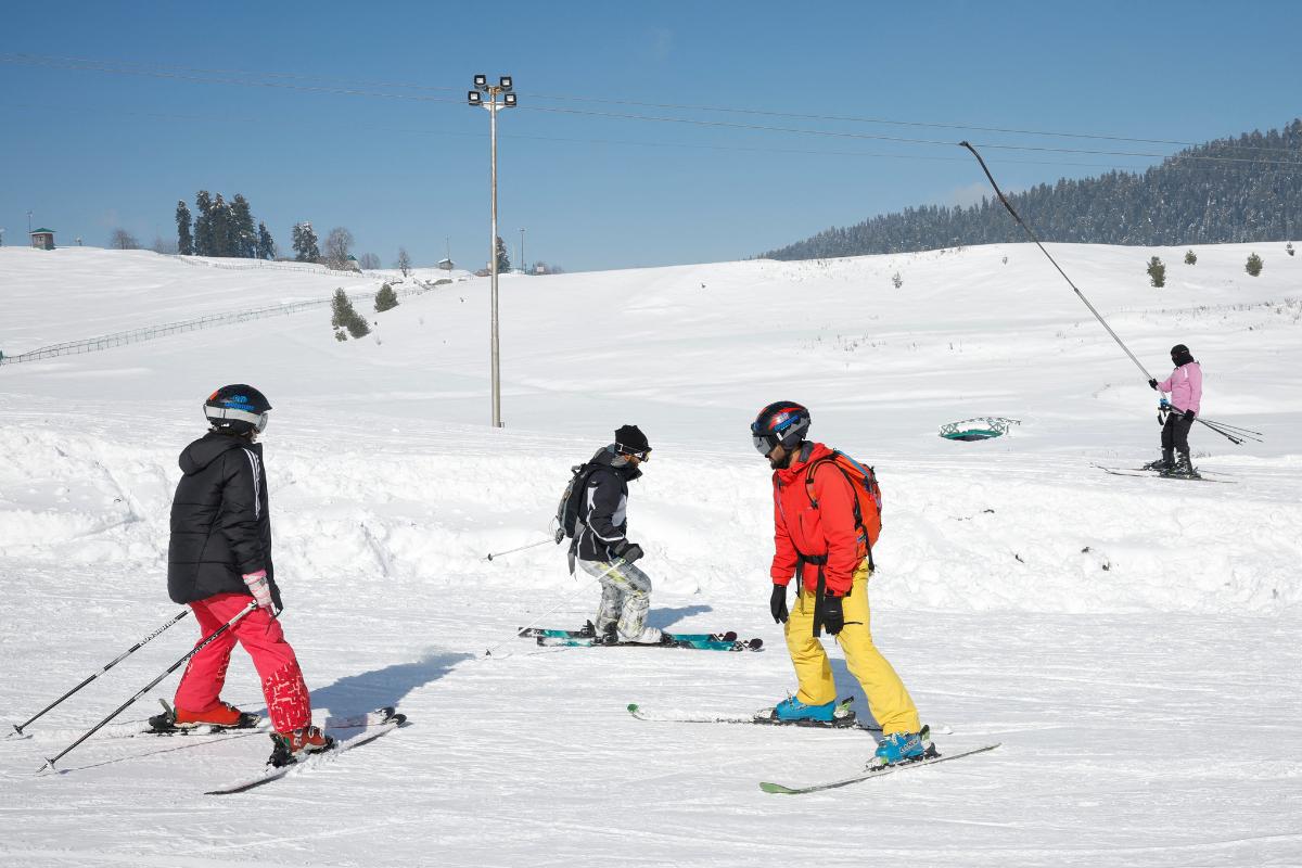 Skiers ski after a traning session in a snow-covered field in Gulmarg, a ski resort and one of the main tourist attractions in the Kashmir region, on January 7, 2025. A similar lack of snowfall last January had caused a drop in visitors to ski resorts and hotels in the Himalayan region, which is claimed in full by India and Pakistan but ruled in part by both.