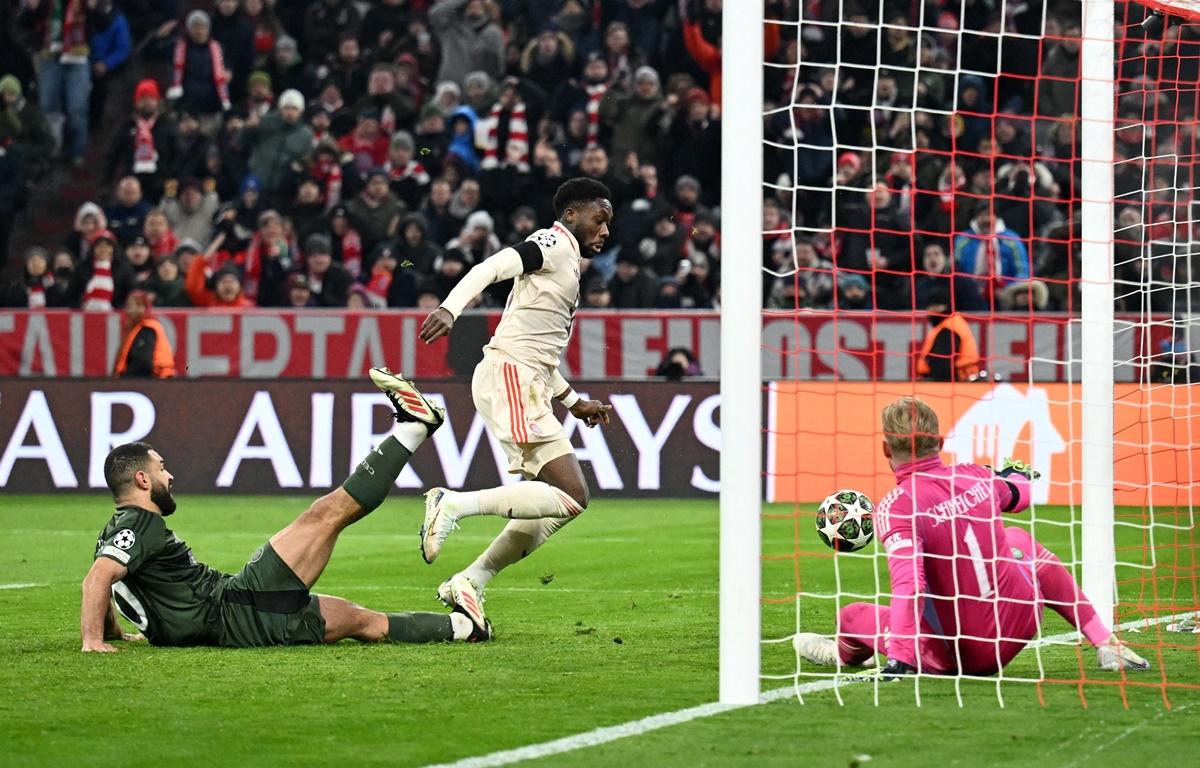 Bayern Munich's Alphonso Davies scores in stoppage past Celtic goalkeeper Kasper Schmeichel at Allianz Arena, Munich, Germany.