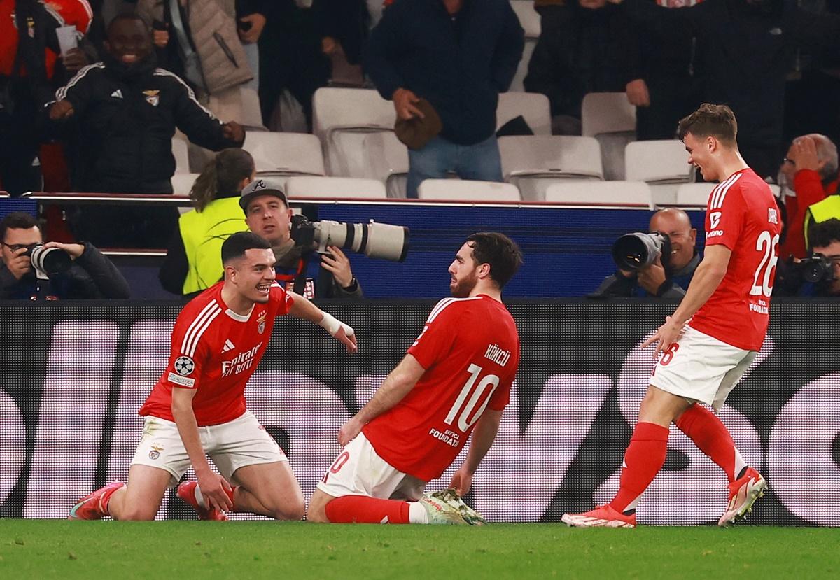 Orkun Kokcu celebrates with teammates after scoring Benfica's third goal against Monaco, at Estadio da Luz, Lisbon, Portugal.