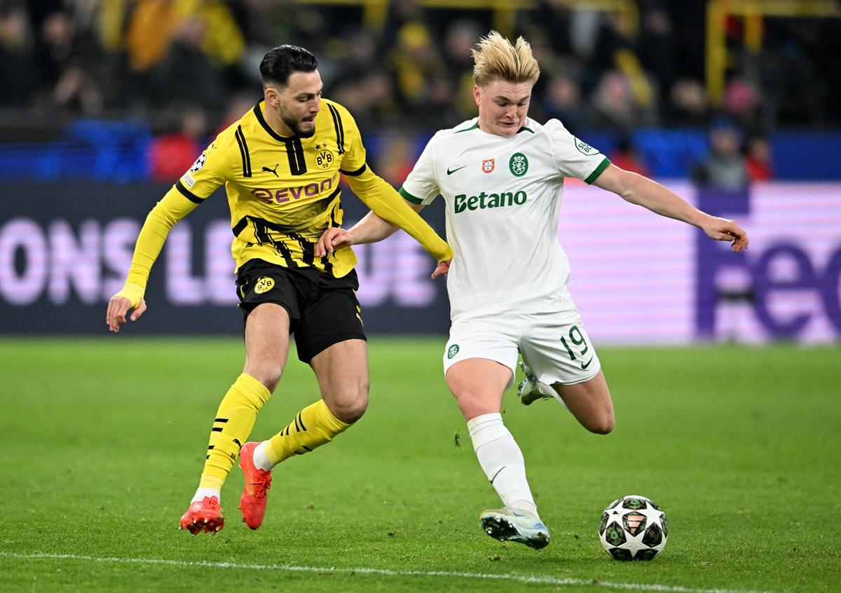 Borussia Dortmund's Ramy Bensebaini in action with Sporting CP's Conrad Harder during their match at Signal Iduna Park, Dortmund, Germany.