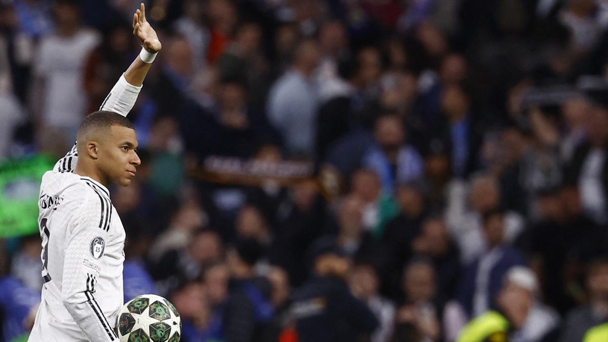 Real Madrid's hat-trick hero Kylian Mbappe celebrates after the Champions League Knock-out phase play-off second leg match against Manchester City while holding the match ball, at Santiago Bernabeu, Madrid, Spain, on Wednesday.