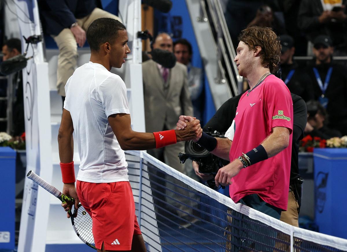 Andrey Rublev and Felix Auger Aliassime meet at the net after their semi-final.