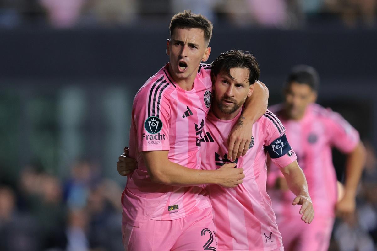 Tadeo Allende (No. 21) celebrates with Lionel Messi after scoring Inter Miami's third goal against Sporting Kansas City.