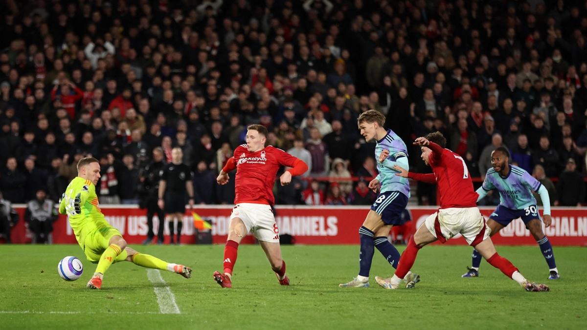 Nottingham Forest's goalkeeper Matz Sels makes a save to deny Arsenal's Martin Odegaard a goal in the match at The City Ground, Nottingham.