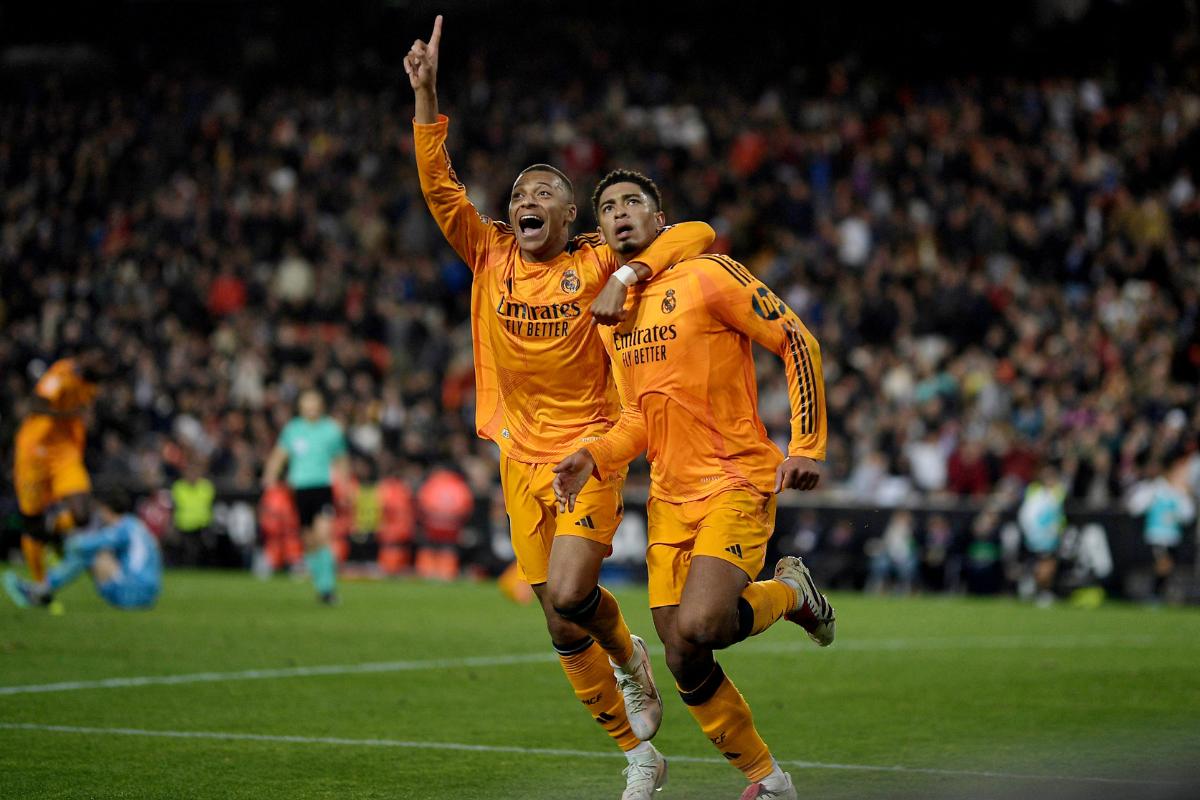 Real Madrid's Jude Bellingham celebrates with Kylian Mbappe after scoring their second goal against Valencia at Estadio de Mestalla, Valencia, Spain, on Friday