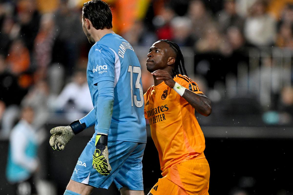 Real Madrid's Vinicius Junior clashes with Valencia's Stole Dimitrievski before he is shown a red card by referee Cesar Soto Grado 