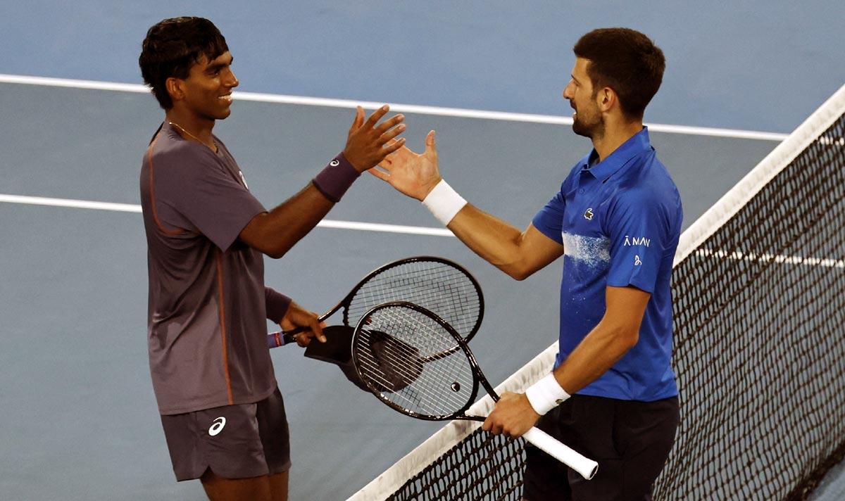 Novak Djokovic greets Nishesh Basavareddy