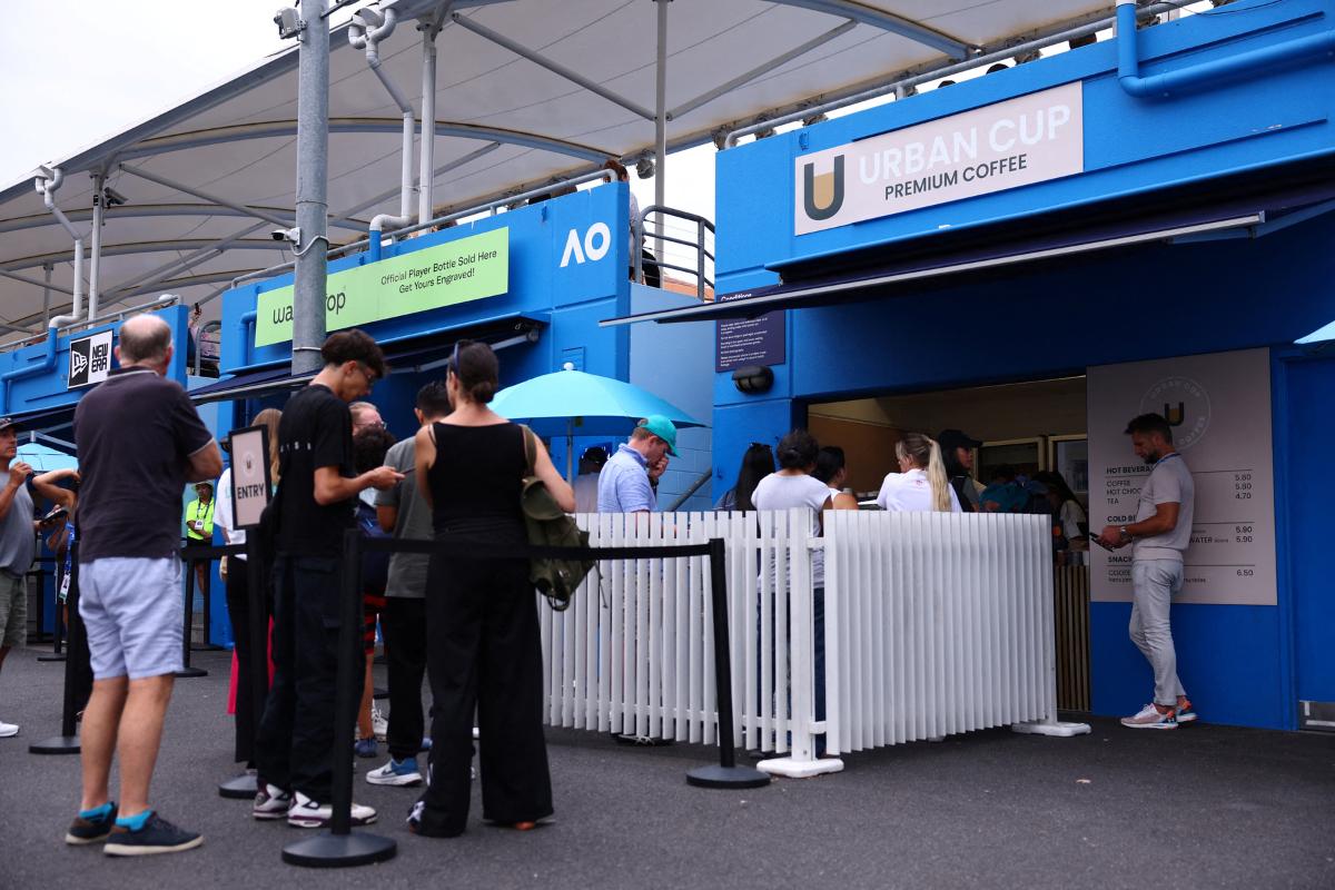 Fans at the Australin Open queue up at a coffee kiosk outside the courts at Melbourne Park on Wednesday