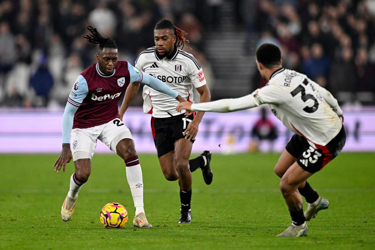 West Ham United's Aaron Wan-Bissaka in action with Fulham's Alex Iwobi and Antonee Robinson