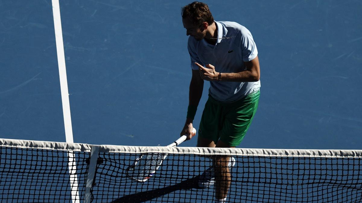 Russia's Daniil Medvedev reacts while holding his smashed racquet after hitting a net camera during his first round match against Thailand's Kasidit Samrej at the Australian Open.