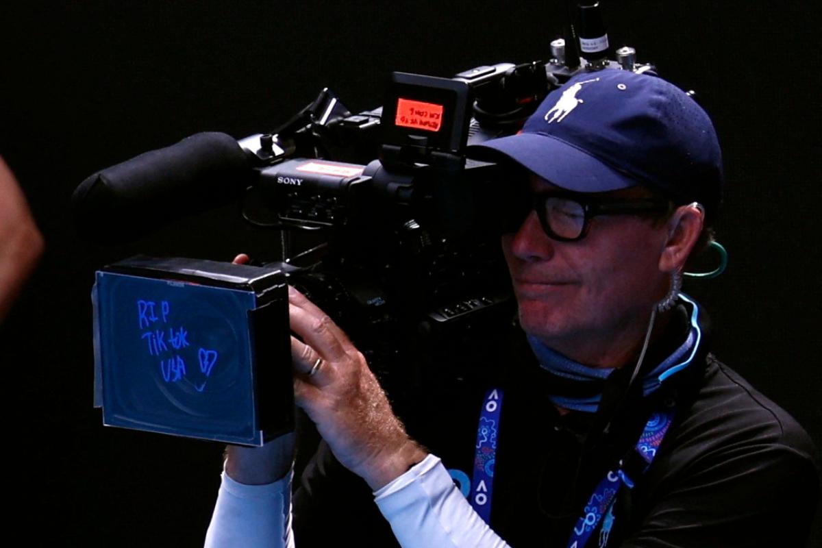 USA's Coco Gauff of the US writes a message on broadcast channel's camera after winning her fourth round match against Switzerland's Belinda Bencic at the Australian Open on Sunday 