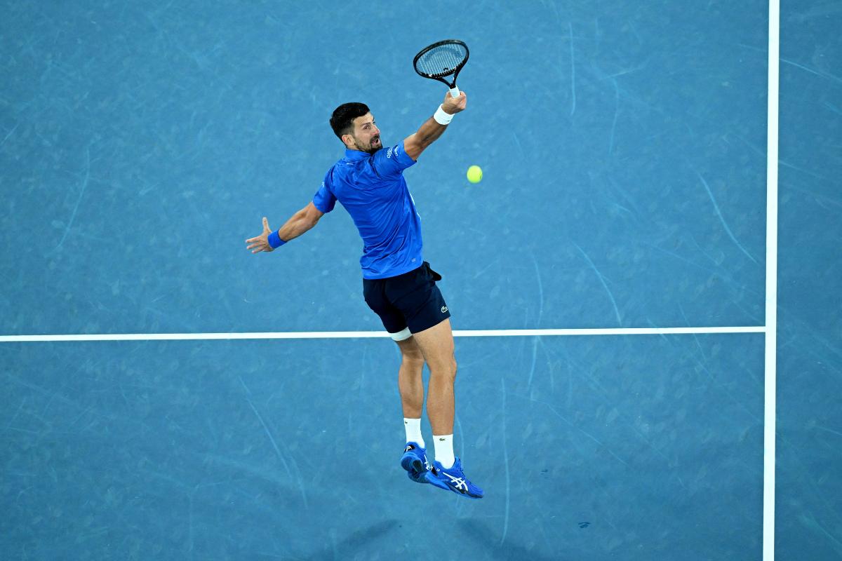 Serbia's Novak Djokovic goes airborne as he plays a return