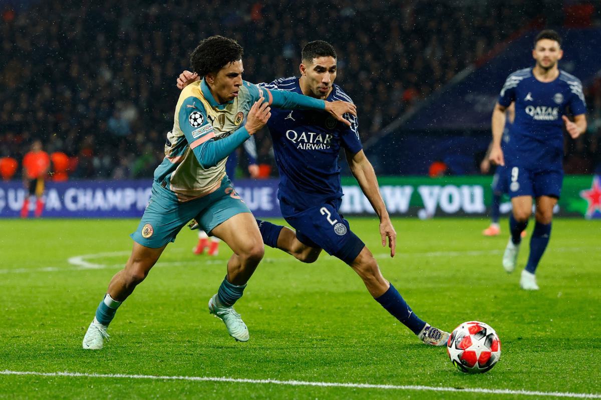 Manchester City's Rico Lewis in action with Paris St Germain's Achraf Hakimi