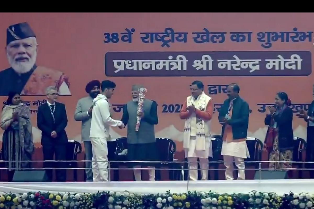 PM Modi receives the ceremonial torch from Olympian Lakshya Sen