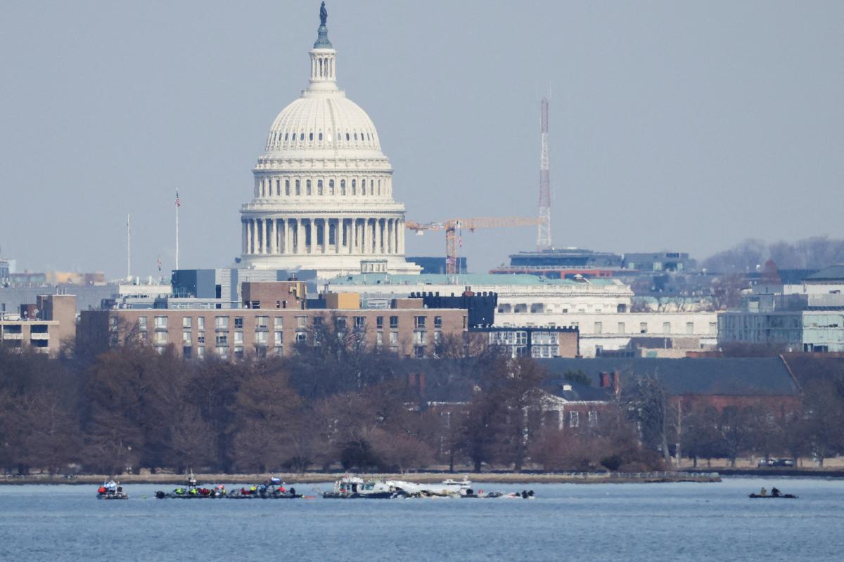 Search and rescue teams work in the aftermath of the collision of American Eagle flight 5342 and a Black Hawk helicopter that crashed into the Potomac River, with the Capitol dome in the background, as seen from Virginia, US, January 30, 2025.