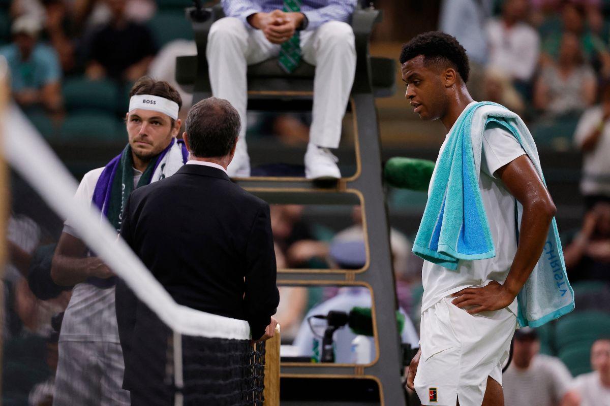 USA's Taylor Fritz and France's Giovanni Mpetshi Perricard react after his first round match gets suspended on Monday