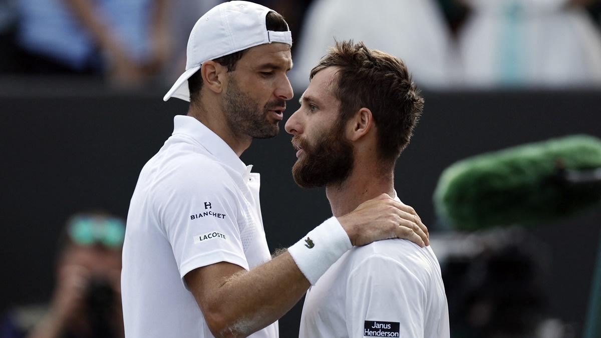 Grigor Dimitrov embraces France's Corentin Moutet after winning his second round match.