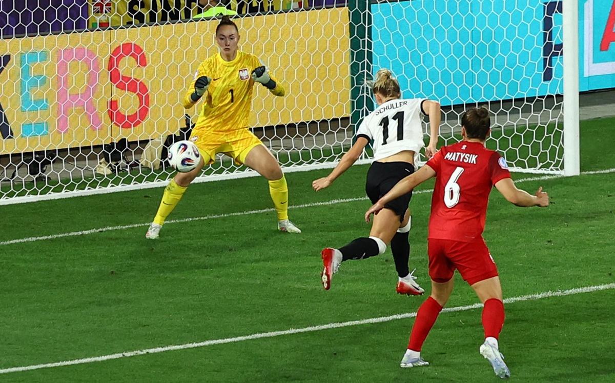 Lea Schuller sends the ball past Poland's Kinga Szemik for Germany's second goal.