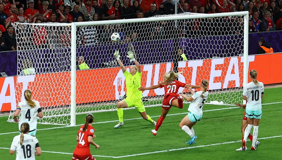 Iceland goalkeeper Cecilia Runarsdottir saves a shot from Switzerland's Alayah Pilgrim.