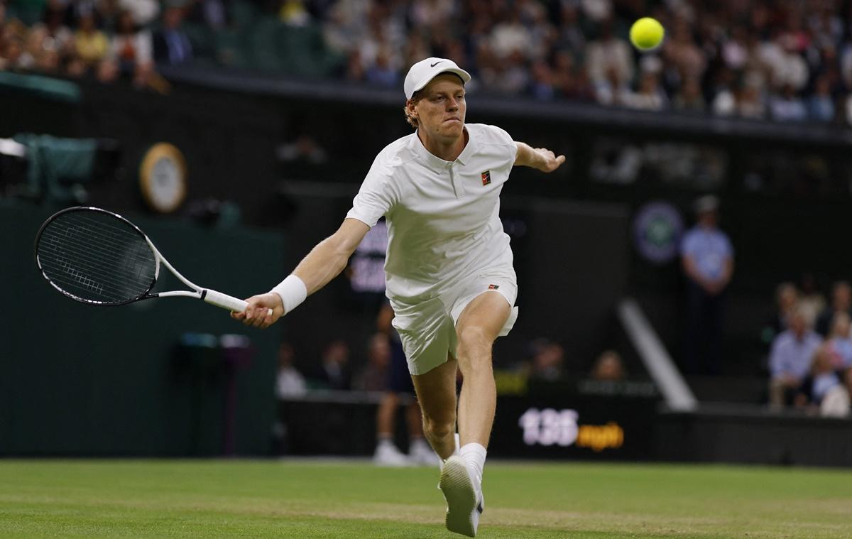Jannik Sinner stretches fully to return one from Grigor Dimitrov.