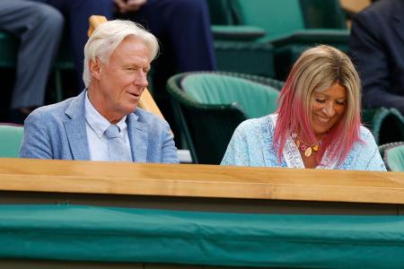 Five-time Wimbledon gentlemen's singles champion Bjorn Borg (L) talks with wife Patricia (R) in the Royal Box
