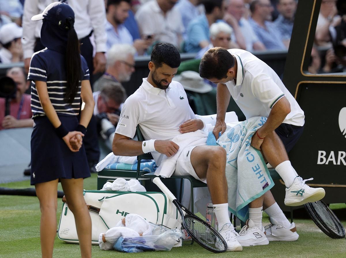 Novak Djokovic receives medical attention during the semi-final.