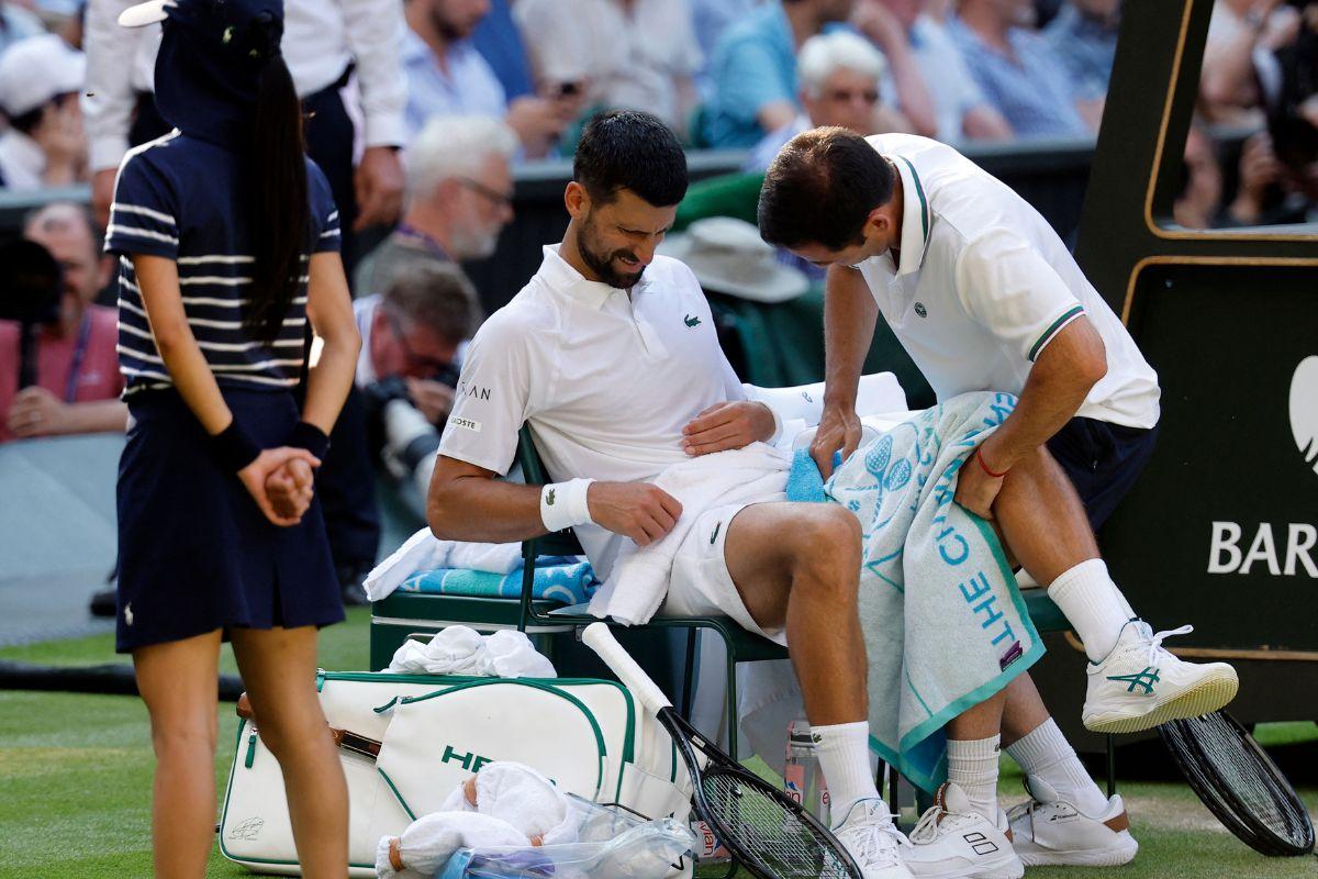 Serbia's Novak Djokovic receives medical attention during his semi-final match against Italy's Jannik Sinner 