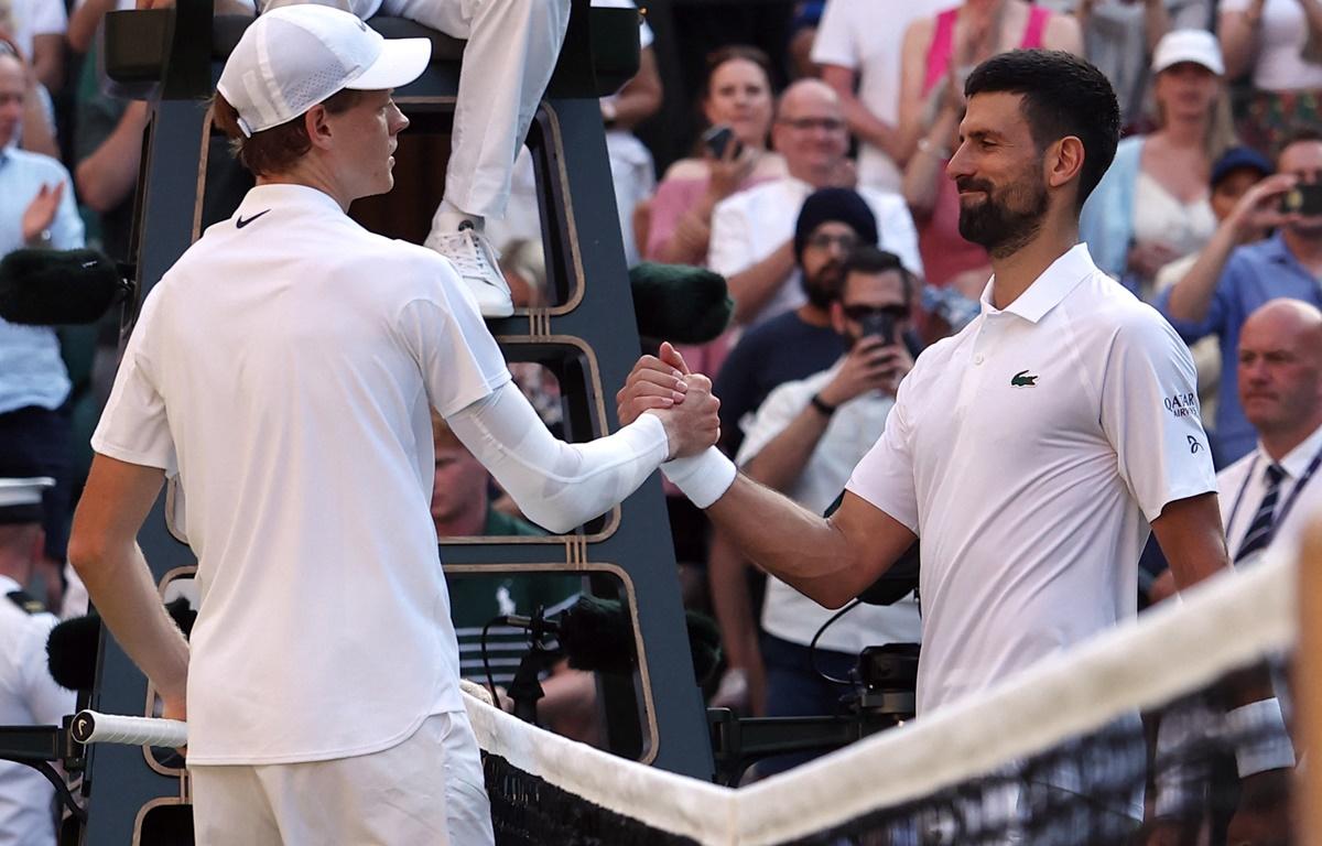 Jannik Sinner and Novak Djokovic meet at the net after their semi-final.
