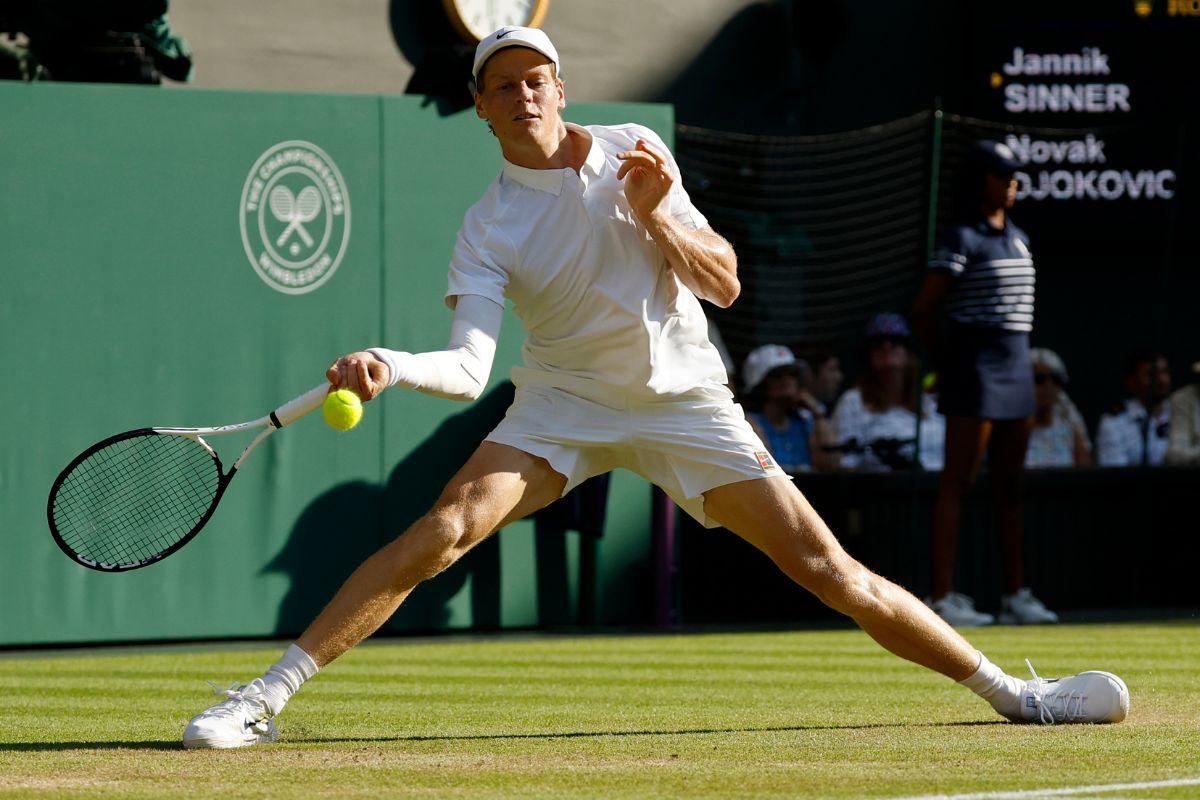 Jannik Sinner plays a return against Novak Djokovic