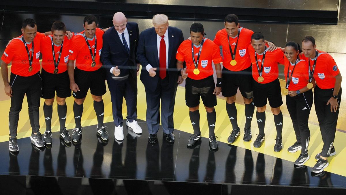 US President Donald Trump and FIFA president Gianni Infantino pose for a picture with referee Alireza Faghani and the other Club World Cup final match officials.