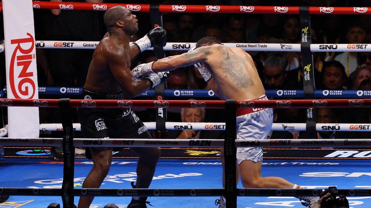 Oleksandr Usyk throws a power-packed punch to knock down Daniel Dubois.