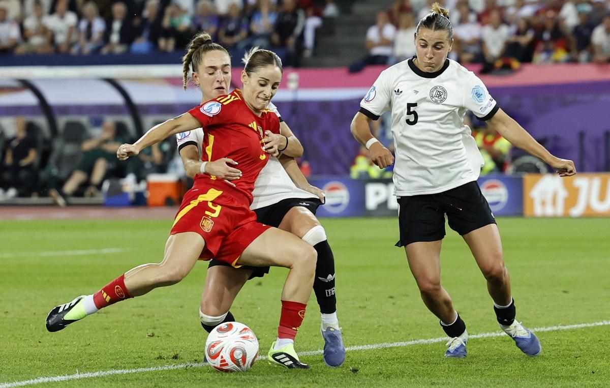 Spain's Esther Gonzalez is checked in her stride by in Germany's Carlotta Wamser and Sophia Kleinherne.