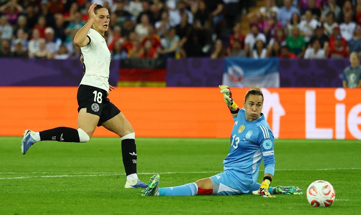 Spain's goalkeeper Catalina Coll watches anxiously as Germany's Giovanna Hoffmann misses a chance to score.