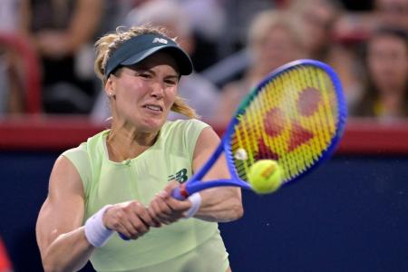 Canada's Eugenie Bouchard returns the ball against Colombia's Emiliana Arango in first round play at IGA Stadium in Montreal, Canada, on Monday