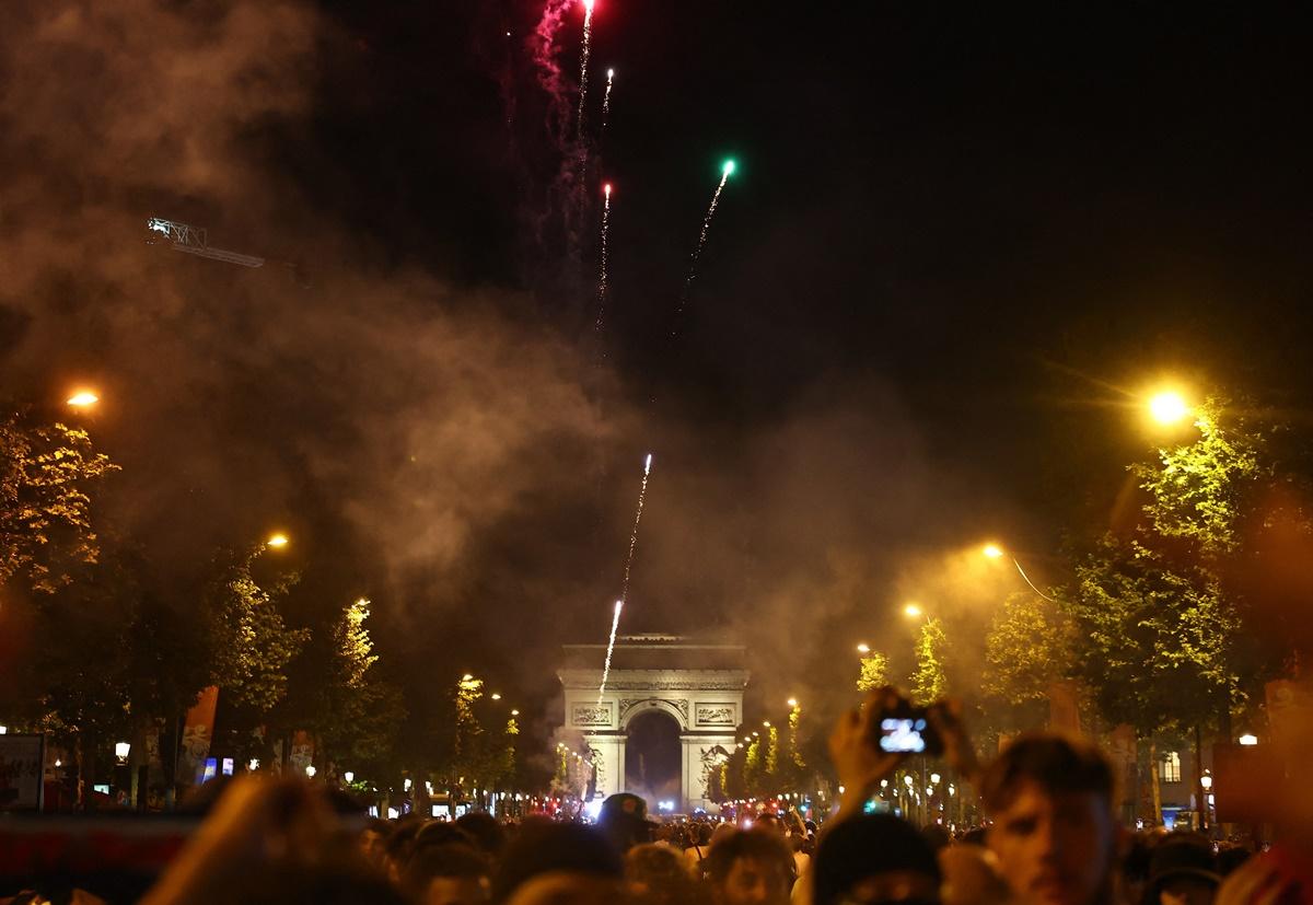 Fans celebrate with flares on the Champs Elysees avenue near the Arc de Triomphe after Paris St Germain complete a 5-0 rout of Inter Milan in the final.