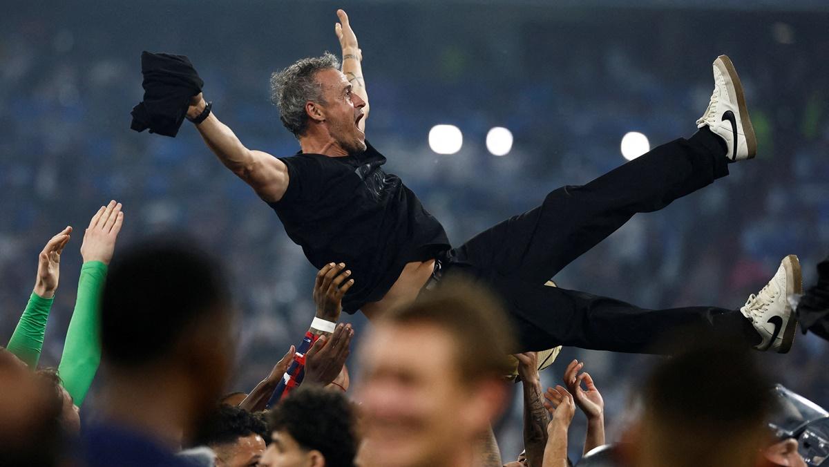 Paris St Germain players celebrate winning the Champions League by throwing Luis Enrique in the air after the final against Inter Milan at Allianz Arena, Munich, on Saturday.