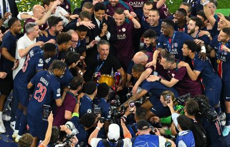 Luis Enrique and his players celebrate with the trophy.