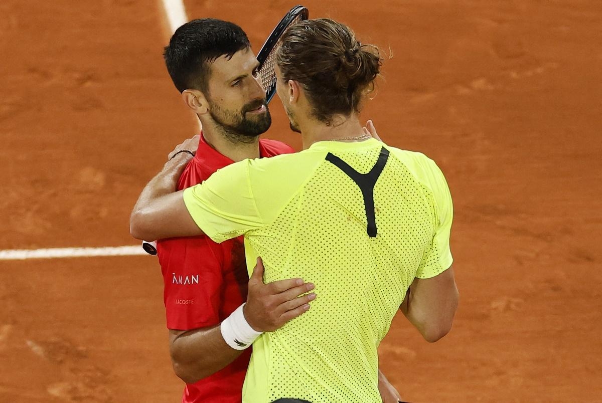 Novak Djokovic and Alexander Zverev embrace after the match.