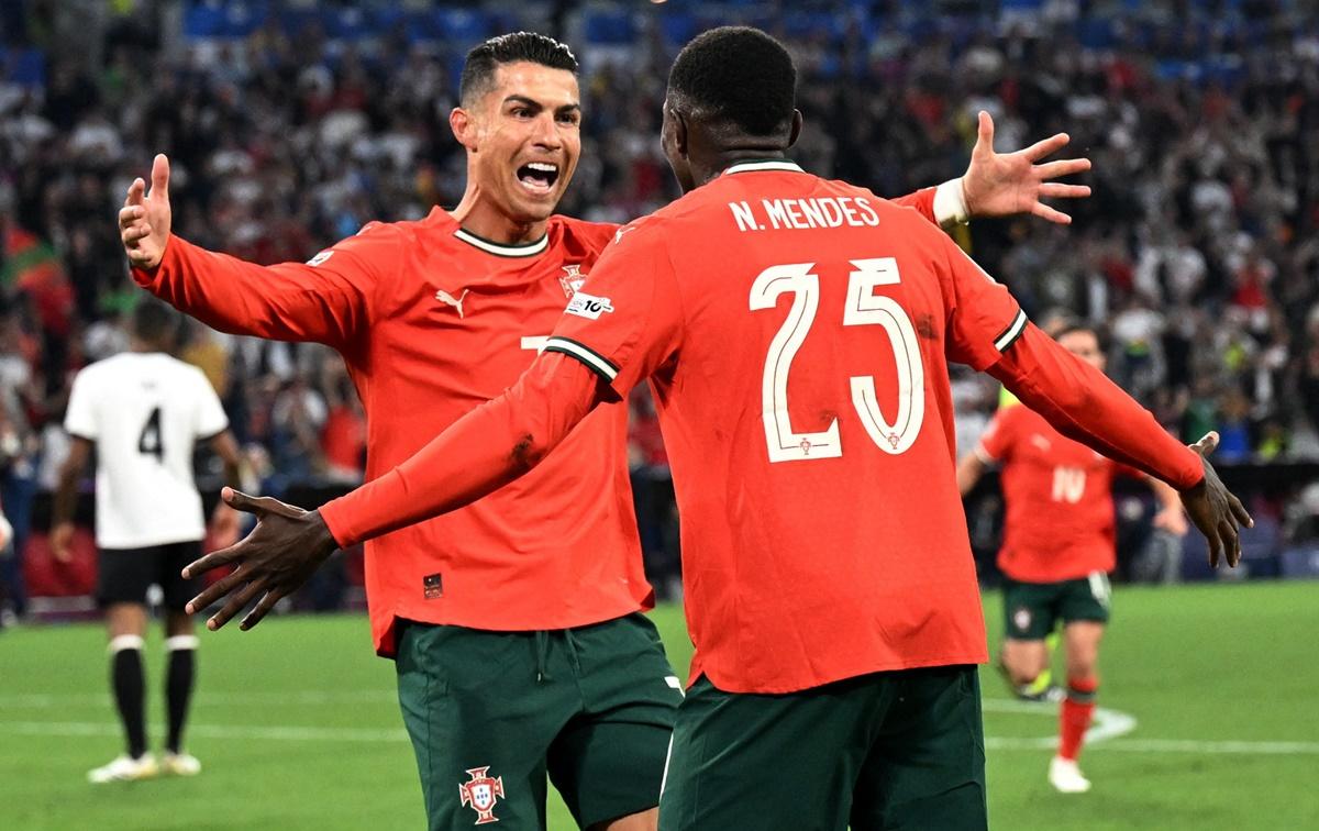 Cristiano Ronaldo celebrates scoring Portugal's second goal with Nuno Mendes