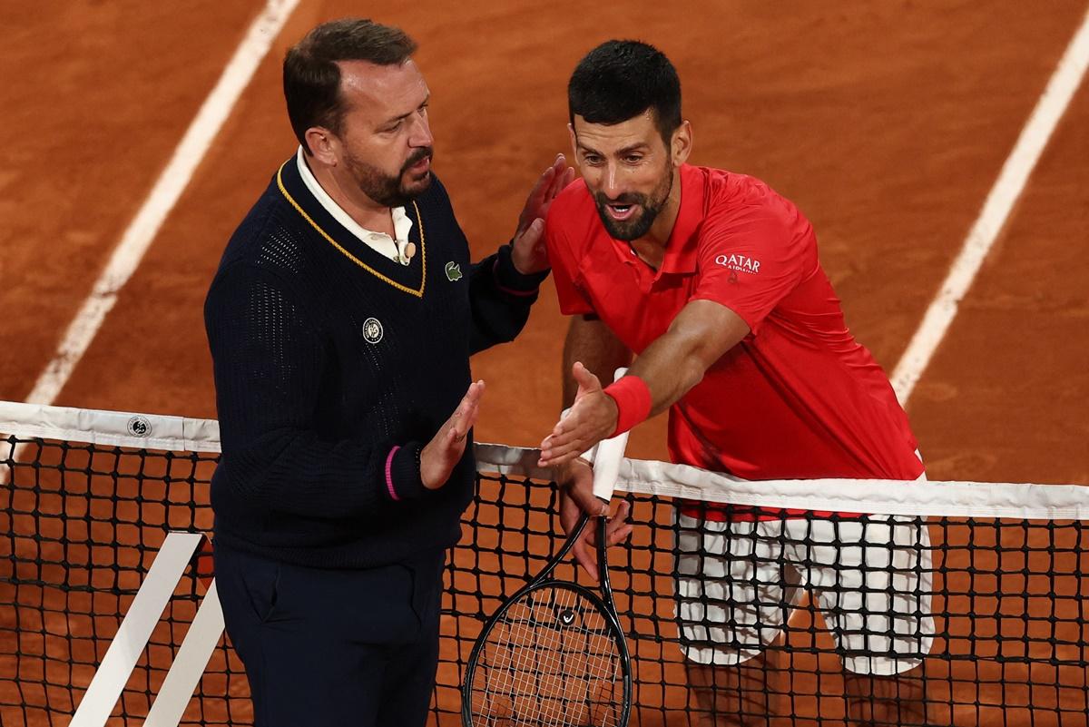 Novak Djokovic remonstrates with umpire Damien Dumusois following a close line call.