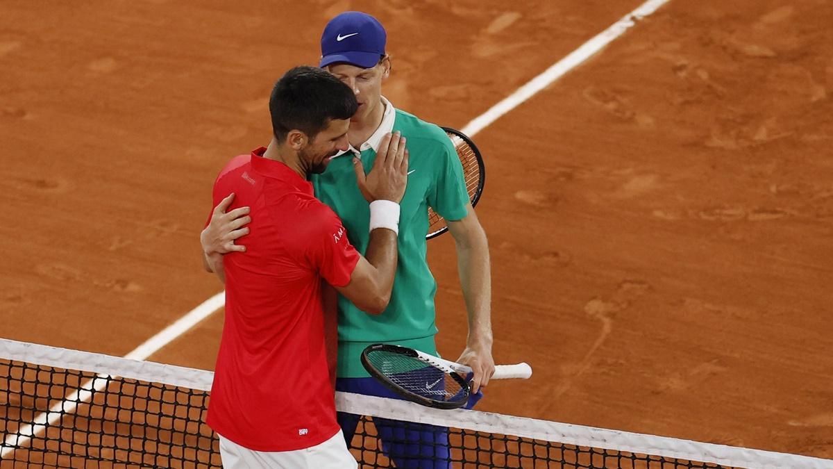 Jannik Sinner and Novak Djokovic embrace after the match.