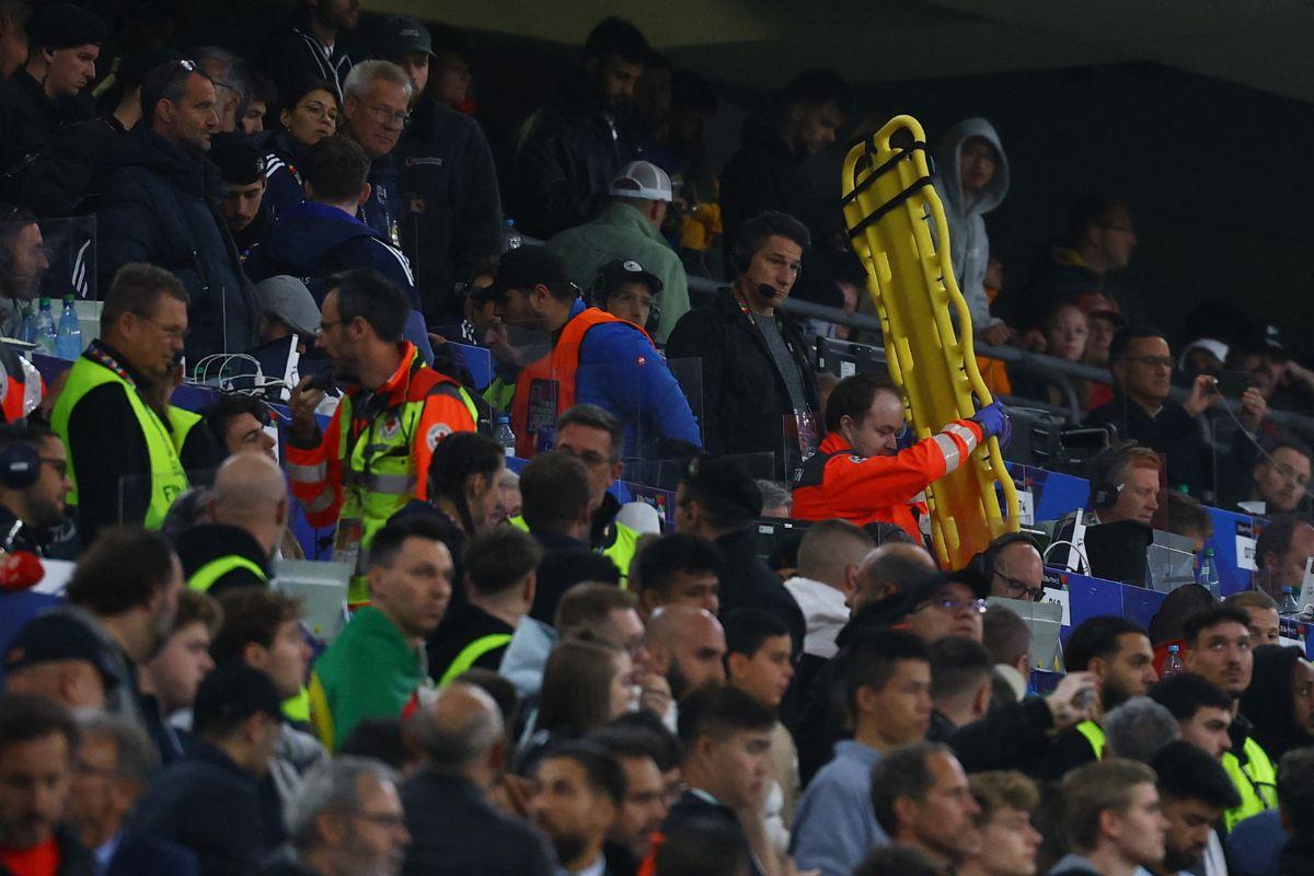 Paramedics brings a stretcher in the stands after an incident with a fan during the Nations League Final match on Sunday 