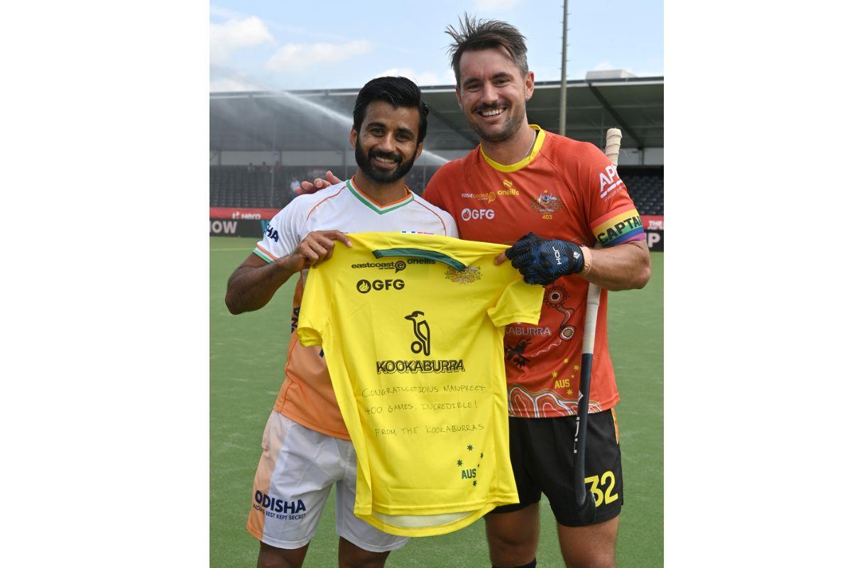 India's Manpreet Singh is presented a special jersey by Australian captain Jeremy Hayward on completing the special landmark of 400 international matches